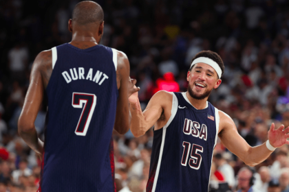 Teammates Kevin Durant (left) and Devin Booker (right) celebrate Team USA's 98-87 win over France. Photo courtesy of USA Basketball/X